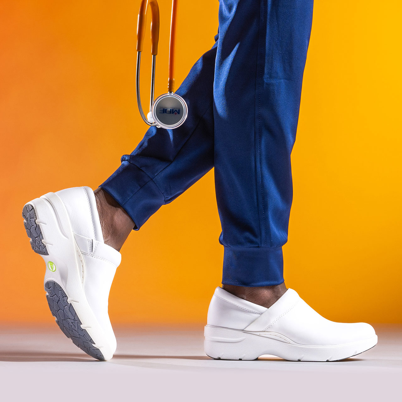 Woman wearing the Align&trade; Indya slip-on shoe in White on foot.