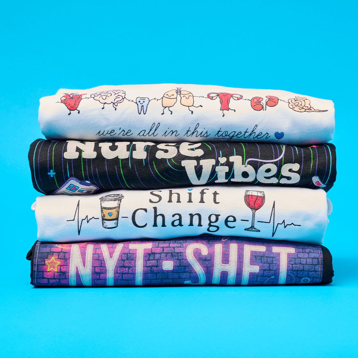 Stack of Nurse Graphic T-Shirts on a blue background.