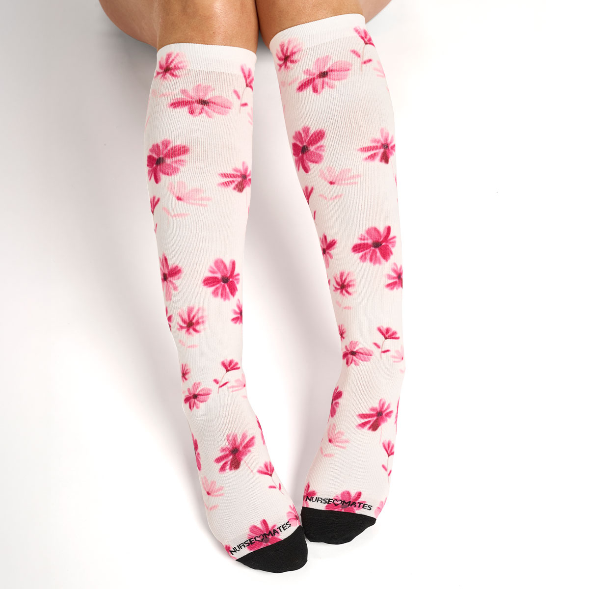 Woman wearing the compression socks 360 in Pink Blossoms.