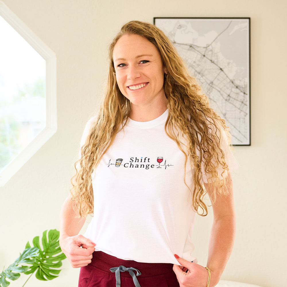 Ella is smiling at the camera, wearing the Shift Change Graphic T-Shirt.